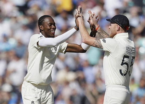 England's Jofra Archer celebrates with England's Ben Stokes after taking the wicket of Australia's Marnus Labuschagne during the second day of the fifth Ashes test match between England and Australia at the Oval cricket ground in London, Friday, September