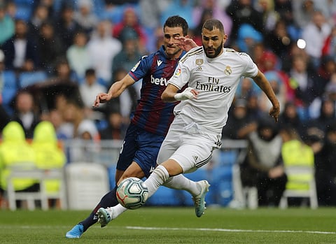Real Madrid's Karim Benzema, right, vies for the ball with Levante's Nemanja Radoja | AP