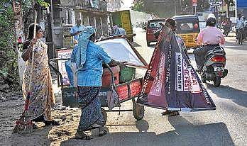 Corporation workers removing illegal hoardings placed at Vayalur Road in Tiruchy on Saturday | M K Ashok Kumar