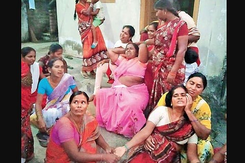 The grief-stricken family members of the boat capsize victims at  Kadipikonda village in Warangal Urban district on Sunday.