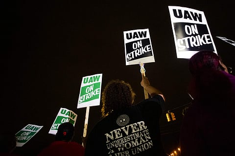 UAW members protest as General Motors employees leave the Flint Assembly Plant at midnight as part of the national strike on Monday, in Michigan. (Photo | AP)