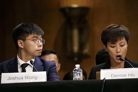 Hong Kong activist Joshua Wong, left, listens as activist and singer Denise Ho, testifies at a congressional hearing on Capitol Hill in Washington. (Photo | AP)
