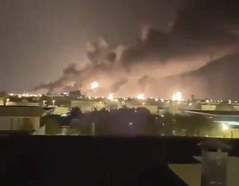 Smoke fills the sky at the Abqaiq oil processing facility on Saturday in Saudi Arabia. (Photo | AP)