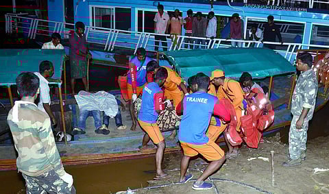 APSDRF personnel rescue passengers of a boat which capsized in the swollen Godavari river in East Godavari district of Andhra Pradesh. (Photo | PTI)