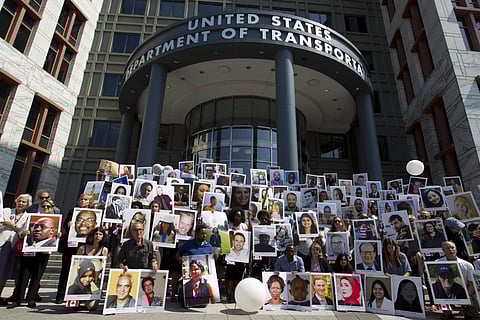 Demonstrators hold pictures of the plane crash victims during a vigil. ( File Photo | AP )