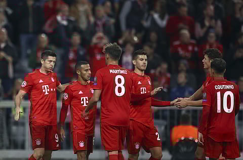Bayern's Robert Lewandowski, left, celebrates with teammates after scoring his side's second goal. (Photo | AP)