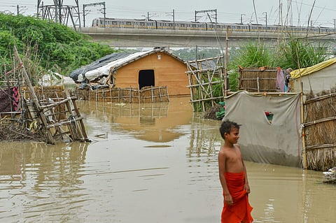A boy stands in the flood waters near the banks of Yamuna River (File Photo | PTI)