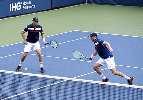 Mike Bryan, left, returns a shot as his brother Bob Bryan, looks on. (Photo | AP)