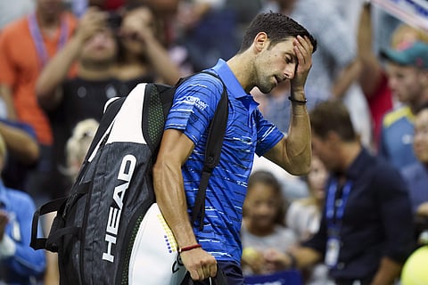 Novak Djokovic, of Serbia, walks off the court as he retires during his match against Stan Wawrinka, of Switzerland, during the fourth round of the U.S. Open tennis championships. (Photo | AP)