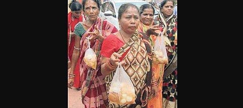 Women show rasagolas distributed by Utkal Mistanna Byabasayee Samiti in Bhubaneswar on Monday