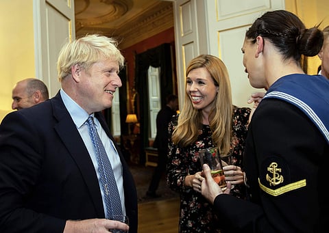 Britain's Prime Minister Boris Johnson and his girlfriend Carrie Symonds, center, speak to guests at a military reception held at 10 Downing Street, London. (Photo | AP)