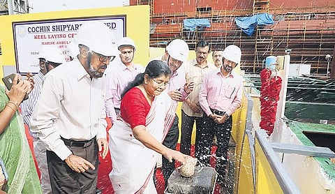 Fisheries Minister J Mercykutty Amma carrying out ‘keel laying’ ceremony for the construction of marine ambulance boats at Cochin Shipyard by breaking open a coconut | Express