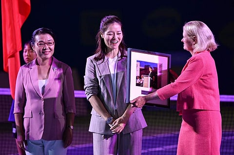 Retired Chinese tennis star Li Na (C) receives a tribute from the Tennis Hall of Fame during the opening ceremony on the first day of action at the Wuhan Open tennis tournament in Wuhan. (Photo | AP)
