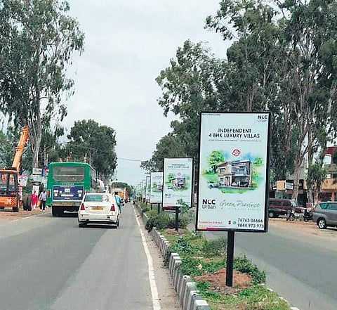 Hoardings dot a median on Sarjapur Road | express