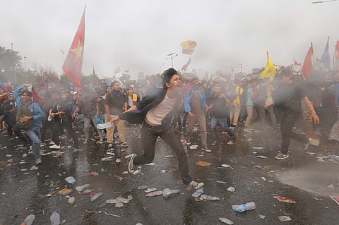 Jakarta Student protesters are sprayed with a police water cannon truck during a protest outside the parliament in Jakarta Indonesia Tuesday Sept. 24 2019. (Photo | PTI)
