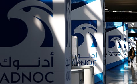 Logos of ADNOC are seen in Chiba, Japan (File Photo| Reuters)