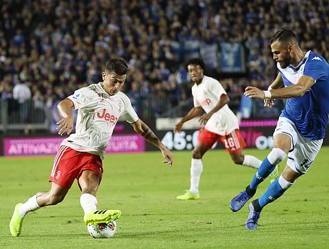 Juventus' Paulo Dybala, left, takes on Brescia's John Chancellor during the Italian Serie A soccer match between Brescia and Juventus at the Rigamonti stadium in Brescia, Italy. (Photo | AP)