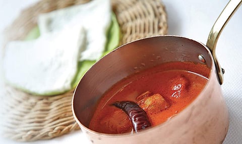 Dishes from Karavalli restaurant Allapuzha Meen Curry and (inset) Maavinkai Mensukkai