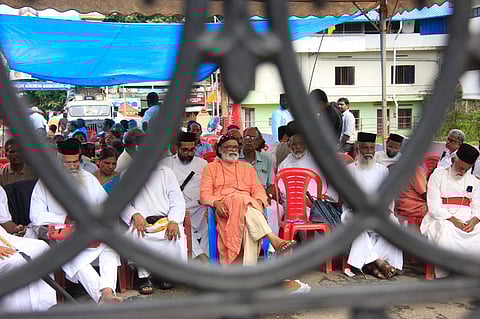 Orthodox faction awaits in front of the gates to enter the church at Piravom on Wednesday. (Photo | Arun Angela, EPS)