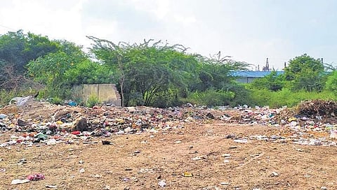 Garbage is strewn across the open area near Golf Links Residency | ( Photo | Somrita Ghosh )