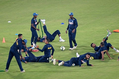Sri Lanka's team warm up before the team cricket practice session at the National Stadium in Karachi. (Photo | AFP)