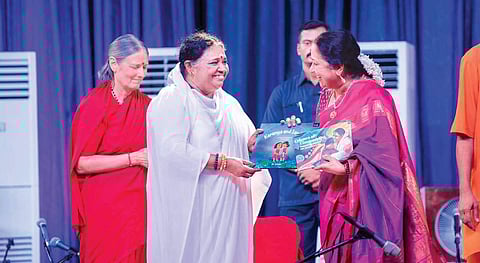 Lakshmi Menon, CEO, TNIE receiving a book from Mata Amritanandamayi as part of a book release function organised ahead of Amma’s birthday  on Thursday