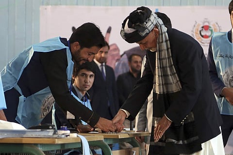 Afghan President Ashraf Ghani, right, inks his finger during the presidential election before he casts his vote at Amani high school, near the presidential palace in Kabul, Afghanistan, Saturday, Sept. 28, 2019. (Photo | AP)