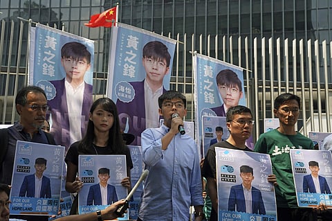 Hong Kong democratic activists Joshua Wong, center, and his supporters speak to the media in Hong Kong, Saturday, Sept. 28, 2019. (Photo | AP)