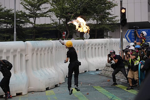A protestor throws molotov cocktail in Hong Kong. (Photo | AP)