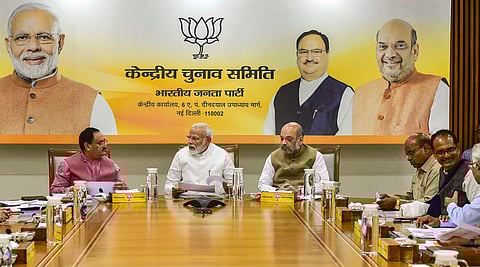 Prime Minister Narendra Modi flanked by Union Home Minister Amit Shah and BJP Working President JP Nadda during party's Central Election Committee CEC meeting in New Delhi. (Photo | PTI)