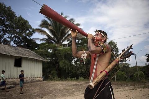 A man plays a horn during a meeting of Tembé tribes in Tekohaw indigenous reserve, Para state, Brazil. (Photo | AP)
