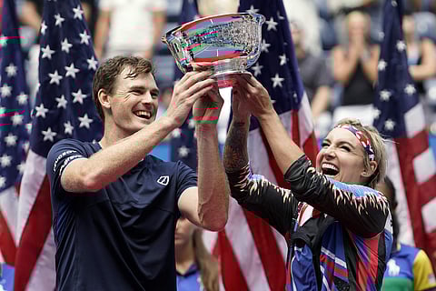 Jamie Murray, of the United Kingdom, left, and Bethanie Mattek-Sands, of the United States, hold up the championship trophy after winning the mixed doubles final against Hao-Ching Chan, of Taiwan, and Michael Venus, of New Zealand, at the U.S. Open tennis