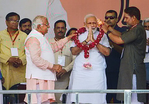 Prime Minister Narendra Modi with Haryana Chief Minister Manohar Lal waves at the crowd during a public rally in Rohtak Sunday September 8 2019. | PTI
