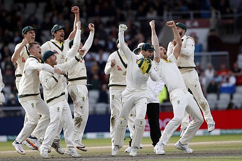 Australia players celebrate after winning the fourth test and retaining the Ashes during day five of the fourth Ashes Test cricket match between England and Australia at Old Trafford in Manchester, England, Sunday Sept. 8, 2019. | AP