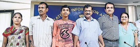 Chief Minister Arvind Kejriwal along with Vijay Kumar, his parents, and sponsor Varun Gandhi (second from right) who will fund the teenager’s education, on Sunday | PARVEEN NEGI