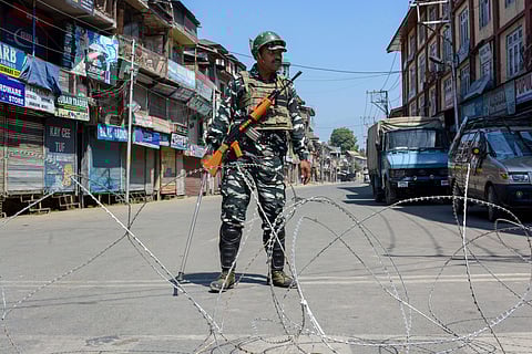 A security person stands guard at a blocked road during restrictions after the abrogration of Article of 370 and bifurcation of state in Srinagar Monday September 9 2019. | PTI