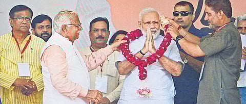 Pm Narendra Modi is being garlanded by Haryana Chief Minister Manohar Lal (left) and another BJP leader at a public rally in Haryana’s Rohtak on Sunday | PTI