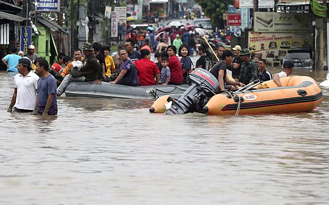 Indonesia rescue team evacuate residents from their flooded house at Jatibening out skirt of Jakarta, Indonesia. (Photo | AP)