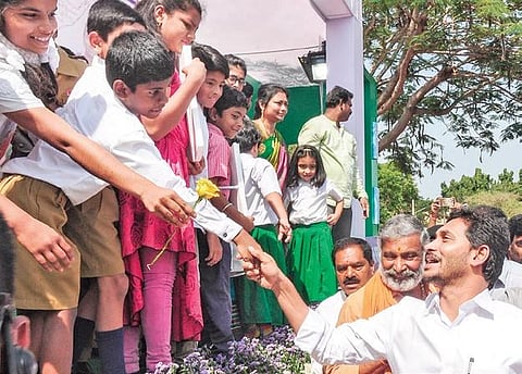 CM Jagan Mohan Reddy greets children at PVKN College in Chittoor on Thursday.  (Photo| EPS/Madhav K)