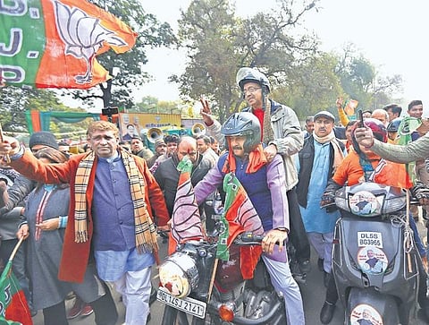 Delhi BJP chief Manoj Tiwari leads a bike rally organised by the party, as Rajya Sabha MP Vijay Goel rides pillion, in New Delhi on Thursday. The rally was flagged off by Lok Sabha MP Meenakshi Lekhi  | Arun Kumar
