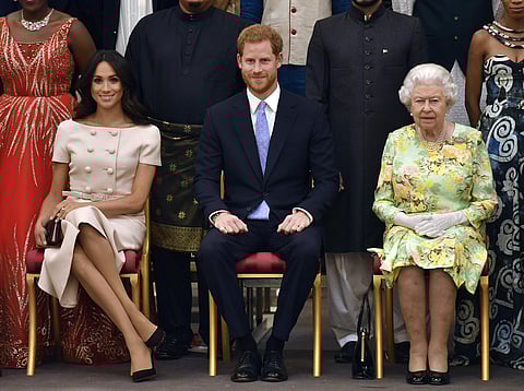Britain's Queen Elizabeth, Prince Harry and Meghan, Duchess of Sussex pose for a group photo at the Queen's Young Leaders Awards Ceremony at Buckingham Palace in London. (File Photo)