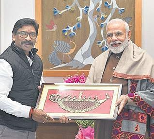 CM Hemant Soren presents a memento to PM Narendra Modi