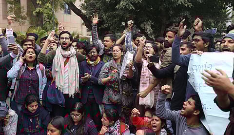 Jamia students shout slogans during a protest against the removal of VC of Jamia Millia outside VC office in New Delhi on Monday.(Photo | Arun Kumar, EPS)
