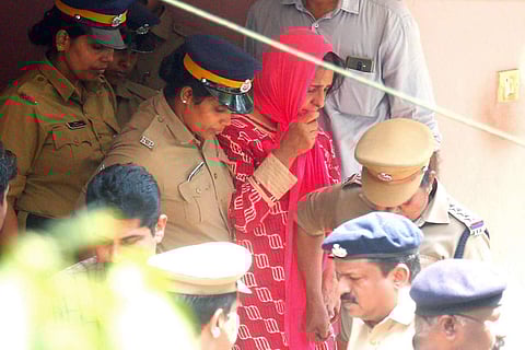 File photo of police taking prime accused Jollyamma to the house of deceased Roy Thomas for collecting evidence at Koodathayi in Thamarassery. ( Photo | TP Sooraj )