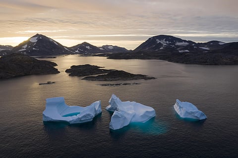 Large icebergs float away as the sun rises near Kulusuk, Greenland. (Photo | AP)