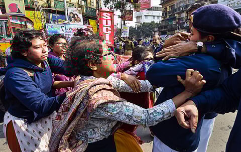 Police detain SUCI activists who were staging a road blockade in support of the trade unions' Bharat Bandh in Kolkata. (File | PTI)