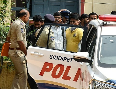 Siddipet police arresting Osmania University prof Dr. Kasim after conducting searches at his house in the staff quarters of Osmania University in Hyderabad on Saturday| Express