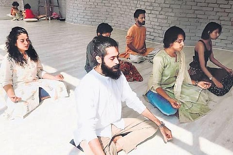 People meditating at a spiritual workshop