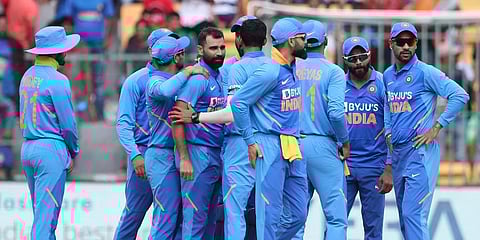 Mohammed Shami, fourth left, celebrates with teammates the dismissal of Australia's David Warner during the third ODI match in Bangalore. (Photo | AP)
