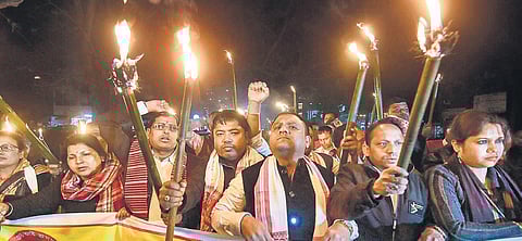 Activists of Sangrami Yuba Parishad take part in a torchlight protest against CAA in Guwahati. (Photo | PTI)